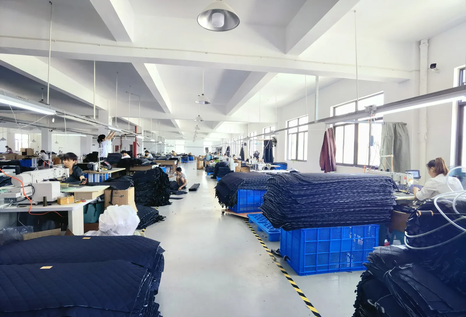 Textile production workstations and pet product components in a manufacturing workshop
